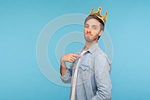 I`m king! Portrait of ambitious man wearing golden crown and pointing himself, looking with arrogance