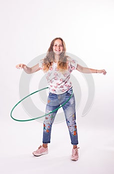 Girl with hula hoops on a white background