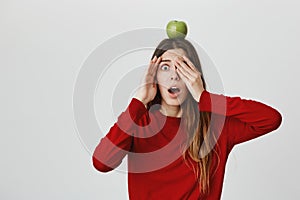 I`m scared. Copy space for advertisement. Young good-looking dark haired european girl in red sweater clothing face with