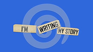 I\'m writing my story. Message on wooden blocks and blue background