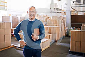 I make distribution look easy. Portrait of a mature man standing on the floor of a warehouse.
