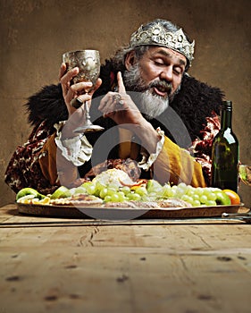 I may...be a wee bit drunks. A mature king feasting alone in a banquet hall. photo