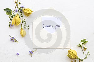 I miss you message card handwriting with ylang flower