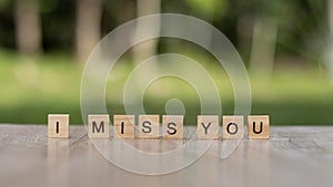 I miss you word Written With wood Blocks On table nature background