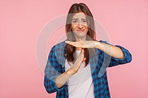 I need more time, enough limits! Portrait of displeased girl in checkered shirt showing time out hand gesture