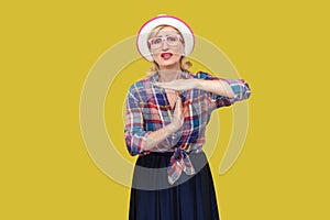 I need more time. Portrait of hopeful modern stylish mature woman in casual style with hat and eyeglasses standing with time