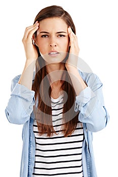 I need a time out. Studio shot of an attractive young woman suffering from a headache against a white background.