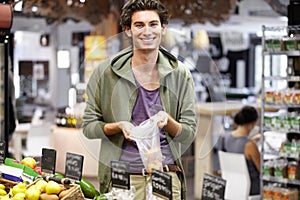 I need to stock up on some fruit. A young man at the store buying fruit.