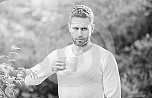 I prefer green tea. Refreshing drink. Man bearded tea farmer hold mug nature background. Green tea contains bioactive photo