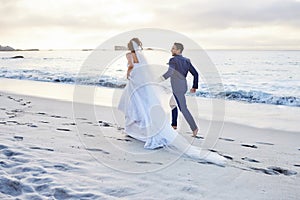 I promise to be your friend and partner every step of the way. a young couple on the beach on their wedding day.