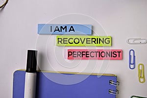 I am A Recovering Perfectionist on sticky notes isolated on white background photo