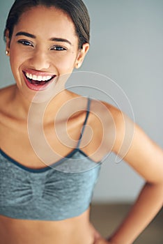 I regret that workout - said no one ever. a sporty young woman posing against a grey background.