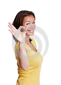 I say ok. Cropped studio shot of an attractive woman in her 30s showing the OK hand signal and smiling at the camera.