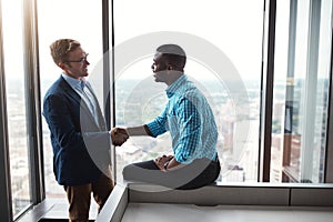 I see the greatness in you. two businesspeople shaking hands in an office.