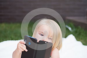 I see you. New technology for children. Small child make video call with smartphone. Small girl with mobile phone. Girl