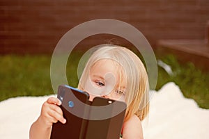 I see you. New technology for children. Small child make video call with smartphone. Small girl with mobile phone. Girl