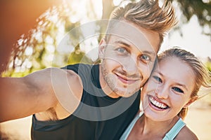 I smile more since I met you. Shot of a young couple smiling outdoors.