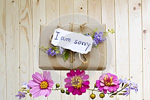 i am sorry message card handwriting with gift box arrangement flat lay postcard style