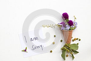 I am sorry message card handwriting with purple flower amaranth in cone