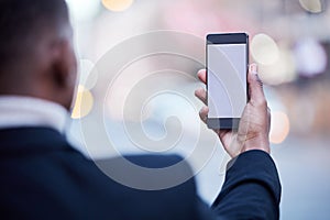 I stay connected from anywhere. Shot of an unrecognizable businessman using a phone in the city.