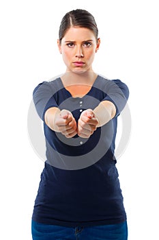 I surrender. Studio shot of a young woman holding out her arms ready to be handcuffed.