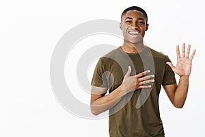 I swear telling truth and only. Charming relaxed and charismatic handsome african american guy pressing palm to hear and photo