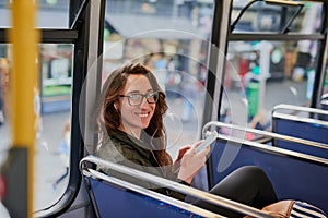 I ALWAYS take the bus. High angle portrait of an attractive young woman listening to music while sitting on a bus.