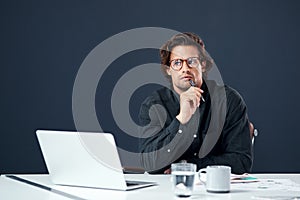 I think Im on to something. Portrait of a handsome young architect looking thoughtful while working on a laptop in his