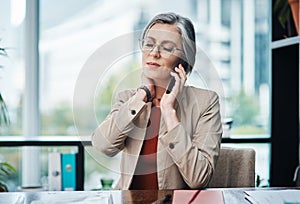 I think Ive been sitting too long. an attractive mature businesswoman sitting and suffering from a sore neck while in