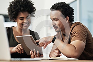 I think you should combine these two ideas. Shot of two young businesspeople sitting together and using a digital tablet