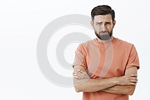 I thought you loved me. Crying bearded 30s guy frowning grimacing in sorrow holding hands crossed over body in defensive
