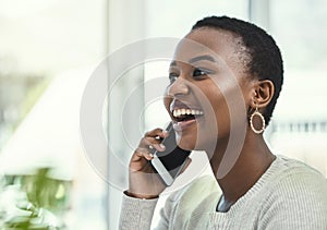 I told you youd be impressed with what I have planned. a young businesswoman talking on her cellphone while sitting at