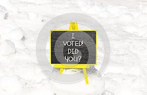 I voted. Did you symbol. Concept words I voted. Did you on beautiful black chalk blackboard. Beautiful white snow background.