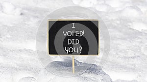 I voted. Did you symbol. Concept words I voted. Did you on beautiful black chalk blackboard. Beautiful white snow background.