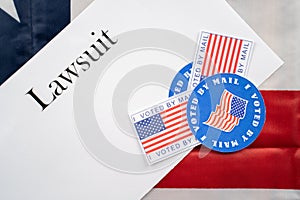 I voted by mail stickers on Lawsuit paper with US flag as background - Concept of lawsuits in USA election