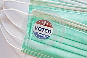 I Voted sticker on protective face mask. Concept of Voting in the USA during coronavirus pandemic