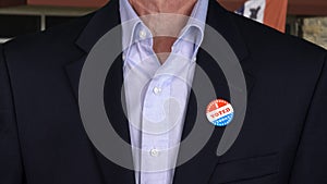 Senior caucasian man in formal clothing with Voted sticker