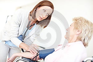 I want to be certain your body isnt under any undue pressure. Mature nurse checks an elderly female patients blood