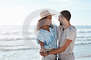 I want to tango through life with you. a young couple dancing together at the beach.