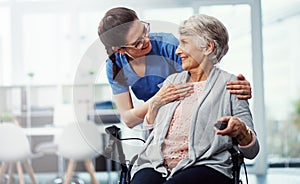 I want your stay here to be as enjoyable as possible. a young female nurse talking to her senior patient in the old age