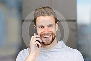 I was waiting for your call. Man beard with smartphone, urban background. Communication concept. Man with beard happy