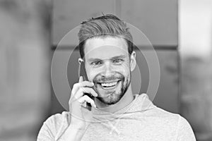 I was waiting for your call. Man beard with smartphone, urban background. Communication concept. Man with beard happy