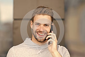 I was waiting for your call. Man beard with smartphone, urban background. Communication concept. Man with beard happy