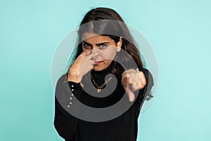 Indian woman pointing at her eyes and camera show I am watching you gesture spying watching someone