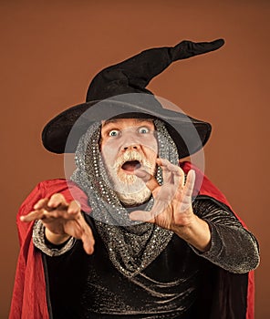 i will catch you. happy halloween. Weird old grandfather with gray beard. Devil man. Holiday and celebration. Magic hat