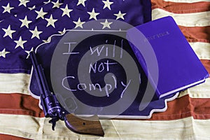 I will not comply gun and Bible on American flag