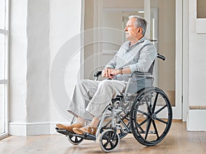 I wish I was in a better stage of my life. Shot of a senior man sitting in a wheelchair and looking thoughtfully out the