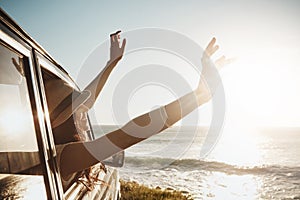 I wish summer would never end. a young woman enjoying a road trip along the coast.