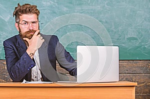 I am your new teacher. Teacher bearded hipster with eyeglasses sit in classroom chalkboard background. School teacher