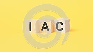 iac text on wooden toy blocks, financial business concept, yellow background. IAC - short for International Accounting photo